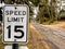 Speed limit 15 sign on a rural road