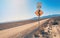 Speed Limit Sign and Curve Sign in desert