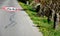 Speed limit sign horizontal markings on asphalt red and white circle 40 km overturned granite bollards in a ditch behind the roads