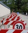 Speed limit sign and hurdles in the road excavation