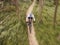 Speed, nature and cyclist on bicycle from above with helmet, exercise adventure trail and forrest fitness. Cycling