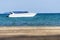 Speedboat is floating over the sea with blur sand beach in foreground in summer in Koh Mak Island at Trat, Thailand