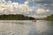 Speedboat Heads Out on a Minnesota Lake Below Dramatic Clouds