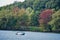 Speedboat in lake Ontario in autumn. Colourful vivid trees. Canada Usa