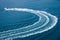 Speedboat runs fast in the open sea and leaves the engine`s wake in the water