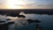 A speedboat sails along the strait at sunset.