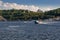 Speedboat sails on the river against the beautiful sky