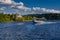 Speedboat sails on the river against the beautiful sky