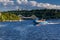 Speedboat sails on the river against the beautiful sky