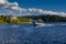 Speedboat sails on the river against the beautiful sky