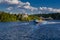 Speedboat sails on the river against the beautiful sky