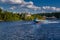 Speedboat sails on the river against the beautiful sky