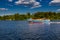 Speedboat sails on the river against the beautiful sky