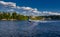 Speedboat sails on the river against the beautiful sky