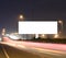 Speeding cars on modern Road infrastructure with blank hoarding for text messages, artistic long exposure shot