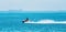 A Speeding Jet Skier On The Ocean At A Coal Loading Port