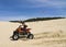 Speeding quad in sand dunes