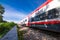 A speeding train on railroad tracks, image blurred by speed. Vivid picture.