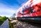 A speeding train on railroad tracks, image blurred by speed. Vivid picture.