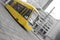 speeding yellow tram with black and white city background