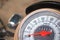 Speedometer on motorcycle dashboard. Round speedometer with red arrow.