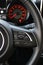 Speedometer With Red Backlight Through Steering Wheel With Speed Control Buttons On It