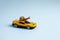 Speedy snail like car racer. Concept of speed and success. Concept of fast taxi or delivery. Yellow car blue background