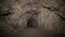 Speleology artificial cave dark tunnel excavation underground. Old adit for the extraction of metal and rocks