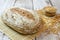 Spelt bread with spelt grain on wooden table