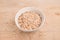 Spelt flakes in a white mixing bowl