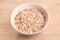 Spelt flakes in a white mixing bowl