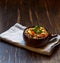 Spelt porridge, a type of wheat in a brown bowl on a wooden rough Board, with space