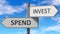 Spend and invest as a choice - pictured as words Spend, invest on road signs to show that when a person makes decision he can