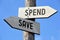 Spend and save - wooden signpost