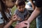 Spend time in nature with father and learn about world around you since childhood. Dad holds butterfly in palm of his hand and