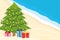 spending christmas in a different way on the tropcial vacation christmas tree with lights and gift boxes on the beach