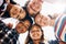 Spending summer days with friends. Low angle portrait of a group of diverse schoolchildren standing in a huddle.