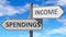 Spendings and income as a choice - pictured as words Spendings, income on road signs to show that when a person makes decision he