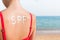 SPF word made of sunblock at woman`s back at the beach. Sun protection factor concept