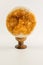 Sphere shaped high quality citrine stone on wooden stand. Decorative using of citrine gemstone. Citrine crystals with healing prop