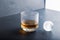 Sphere shaped ice cube and close up whiskey