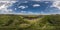 spherical 360 hdri panorama among green grass farming field near melioration reclamation canal in equirectangular seamless