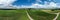 Spherical abstract panoramic aerial view in a field with fantastic beautiful clouds and curvature of space like a small planet