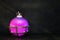 Spherical flask with pink liquid on a dark background