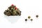 Spice. Allspice, black, white, green and red peppercorns with a pronounced texture close-up