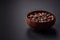 Spice allspice brown color not ground in a wooden saucer. Asian food