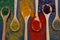 Spice background on wooden spoons. Seasoning texture. Hibiscus, black pepper, paprika, cumin, curry, parsley