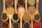 Spice and Food - Background made of many various spices and pepper varieties in small wooden bowls and cooking spoons