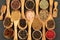 Spice and Food - Background made of many various spices and pepper varieties in small wooden bowls and cooking spoons