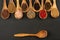 Spice and Food - Nine  cooking spoons made of olive wood in a row filled with spice and pepper varieties